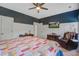 Comfortable main bedroom with ceiling fan, TV, and relaxing reading chair with an oversized quilt at 3025 Rampart Rd, Summerville, SC 29483