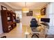 Home office with glass desk, wood floors, and view to modern kitchen at 3025 Rampart Rd, Summerville, SC 29483