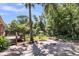 Spacious backyard with mature trees, shed, and small wood deck off the back of the house at 31 Lyttleton St, Charleston, SC 29407