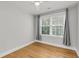 Bright, empty bedroom with a ceiling fan, a large window, hardwood floors and neutral wall color at 31 Lyttleton St, Charleston, SC 29407