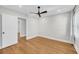 An empty bedroom featuring hardwood floors, a dark ceiling fan, and a connecting door at 31 Lyttleton St, Charleston, SC 29407