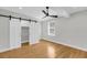 Bright bedroom featuring hardwood floors, modern ceiling fan, and closet with sliding doors at 31 Lyttleton St, Charleston, SC 29407