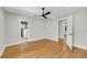 Bright bedroom features hardwood floors, fan, neutral walls and doorways to bathroom and hall at 31 Lyttleton St, Charleston, SC 29407
