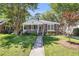 Charming brick home featuring a welcoming front porch and a beautifully landscaped front yard with mature trees at 31 Lyttleton St, Charleston, SC 29407