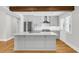 Modern kitchen featuring a large island, stainless steel appliances, white subway tile, and hardwood floors at 31 Lyttleton St, Charleston, SC 29407