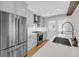 Modern kitchen design with stainless steel refrigerator, oven, grey cabinetry, white countertops, and an undermount sink at 31 Lyttleton St, Charleston, SC 29407
