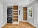 Bright laundry room with lots of storage, modern washer and dryer, and hardwood floors at 31 Lyttleton St, Charleston, SC 29407