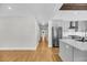 Open-concept living space featuring hardwood floors, neutral paint, and a seamless transition to the modern kitchen at 31 Lyttleton St, Charleston, SC 29407