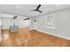An open-concept living space showcasing hardwood floors, large windows, and a seamless transition to the kitchen area at 31 Lyttleton St, Charleston, SC 29407