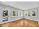 Sunroom featuring hardwood floors, white trim and many windows providing lots of natural light at 31 Lyttleton St, Charleston, SC 29407