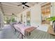 Screened porch with outdoor dining set, ceiling fan, and views of backyard trees at 312 Hobcaw Dr, Mount Pleasant, SC 29464