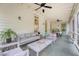 Inviting back porch with comfortable seating and a ceiling fan for outdoor relaxation at 312 Hobcaw Dr, Mount Pleasant, SC 29464