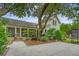 View of a lovely backyard with a large tree providing shade to an outdoor seating area and home at 312 Hobcaw Dr, Mount Pleasant, SC 29464