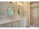 Bathroom featuring double vanity sinks, quartz countertops, framed mirrors, and a glass enclosed shower at 312 Hobcaw Dr, Mount Pleasant, SC 29464