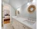 Bright bathroom with double vanity sinks, quartz countertops, and a door leading to the bedroom at 312 Hobcaw Dr, Mount Pleasant, SC 29464