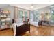 Charming bedroom featuring two twin beds, ample natural light, and stylish decor with hardwood flooring at 312 Hobcaw Dr, Mount Pleasant, SC 29464