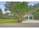 Charming home with a covered porch, mature trees, and a two-car garage with green doors at 312 Hobcaw Dr, Mount Pleasant, SC 29464