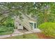 Unique two-story garage with exterior staircase surrounded by mature trees and landscaping at 312 Hobcaw Dr, Mount Pleasant, SC 29464