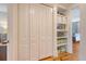 Hallway view features white closets, built-in shelving, and access to a bedroom with hardwood floors at 312 Hobcaw Dr, Mount Pleasant, SC 29464