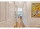 Bright hallway with closet, shelving, and artwork leads to a bedroom with natural light and a ceiling fan at 312 Hobcaw Dr, Mount Pleasant, SC 29464