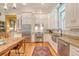 Well-equipped kitchen with stainless steel appliances, stylish cabinetry, and a rustic wooden table at 312 Hobcaw Dr, Mount Pleasant, SC 29464