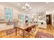 Open living space with hardwood floors, a modern kitchen, a wooden dining table, and stylish decor at 312 Hobcaw Dr, Mount Pleasant, SC 29464