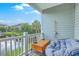 Relaxing balcony with outdoor seating overlooking a serene pond and lush greenery at 313 Lanyard St, Johns Island, SC 29455