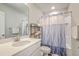 Bright bathroom featuring a shower with a patterned curtain, storage shelves, and vanity with stainless steel faucet at 313 Lanyard St, Johns Island, SC 29455
