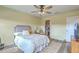 Bedroom featuring a ceiling fan, comfortable bed, rug, and view of a walk-in closet at 313 Lanyard St, Johns Island, SC 29455