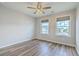 Spacious bedroom with wood-look floors, a ceiling fan, and two windows, filled with natural light at 313 Lanyard St, Johns Island, SC 29455
