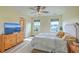 Cozy bedroom with a ceiling fan, two windows, a TV on a dresser, and a comfortable bed at 313 Lanyard St, Johns Island, SC 29455