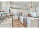 Modern kitchen with white cabinets, stainless steel appliances, and a view into the dining area at 313 Lanyard St, Johns Island, SC 29455