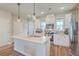 Stylish kitchen features white cabinets, stainless steel appliances, and an island with pendant lighting at 313 Lanyard St, Johns Island, SC 29455