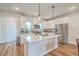 Bright kitchen with stainless steel appliances, white cabinetry, a center island and pendant lighting at 313 Lanyard St, Johns Island, SC 29455
