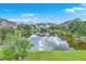 Scenic aerial view of a pond surrounded by well-maintained landscaping and residential buildings at 313 Lanyard St, Johns Island, SC 29455