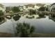 Scenic pond view reflecting the surrounding neighborhood homes and trees on a clear day at 313 Lanyard St, Johns Island, SC 29455