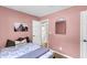 Bedroom with pink walls, wood floors, and an open bathroom at 334 Water Oak Dr, Goose Creek, SC 29445