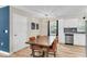 Bright dining area featuring a wooden table, modern chairs, stylish light fixture, and new floors at 334 Water Oak Dr, Goose Creek, SC 29445