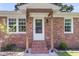 Inviting front entrance with brick steps, wooden support columns, and a decorative screen door at 334 Water Oak Dr, Goose Creek, SC 29445