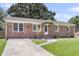 Well-maintained brick house featuring a driveway, lush lawn, and welcoming front entrance at 334 Water Oak Dr, Goose Creek, SC 29445