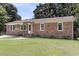 Classic brick house with a well-kept lawn, complemented by mature trees and a cozy front entrance at 334 Water Oak Dr, Goose Creek, SC 29445