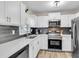 Modern kitchen with white cabinets, stainless steel appliances, and gray subway tile backsplash at 334 Water Oak Dr, Goose Creek, SC 29445