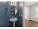 Powder room featuring a pedestal sink with oval mirror and decorative light fixture at 354 Iveson Rd, Summerville, SC 29486