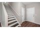 Bright entryway featuring hardwood floors and a staircase with white banister at 354 Iveson Rd, Summerville, SC 29486
