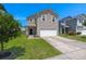 Two-story home with a well-maintained lawn, driveway, and attached two-car garage at 354 Iveson Rd, Summerville, SC 29486