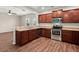 Modern kitchen features stainless steel appliances, wooden cabinets, and laminate countertops at 354 Iveson Rd, Summerville, SC 29486