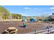 Community playground featuring multiple play structures and areas for children to climb, swing, and slide on a sunny day at 354 Iveson Rd, Summerville, SC 29486