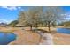 Picturesque walking path along the water, shaded by mature trees, offering a scenic spot for exercise and relaxation at 354 Iveson Rd, Summerville, SC 29486