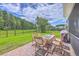 Outdoor dining set sits on the stone patio with grill on a beautiful day in the backyard at 359 Whispering Breeze Ln, Summerville, SC 29486