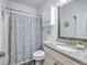 Well-lit bathroom with a shower and tub combination, decorative curtain, and granite topped vanity at 359 Whispering Breeze Ln, Summerville, SC 29486